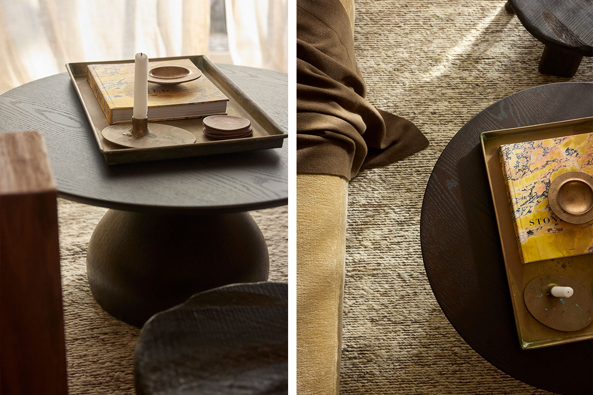 A dark timber round coffee table styled with a textured rug, ideal for small living room ideas.