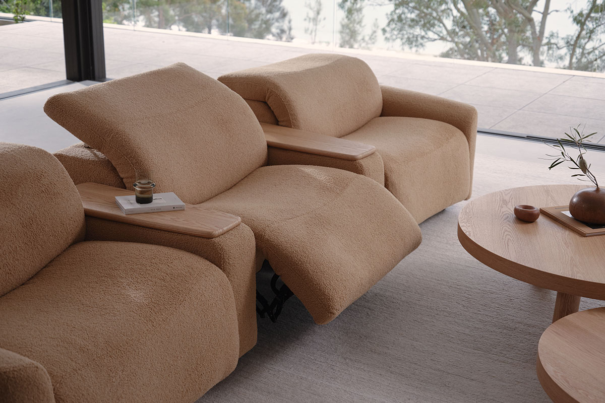 Soft-fabric modular cinema recliner styled for comfortable movie nights, footrest raised for relaxed home theatre viewing.
