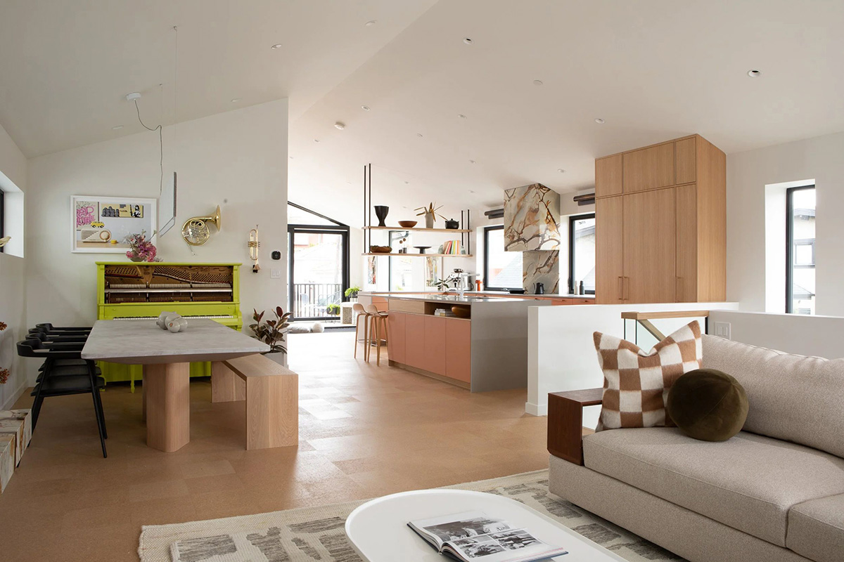 Modern open plan living kitchen and dining space styled with light oak timber joinery and neutral furnishings.