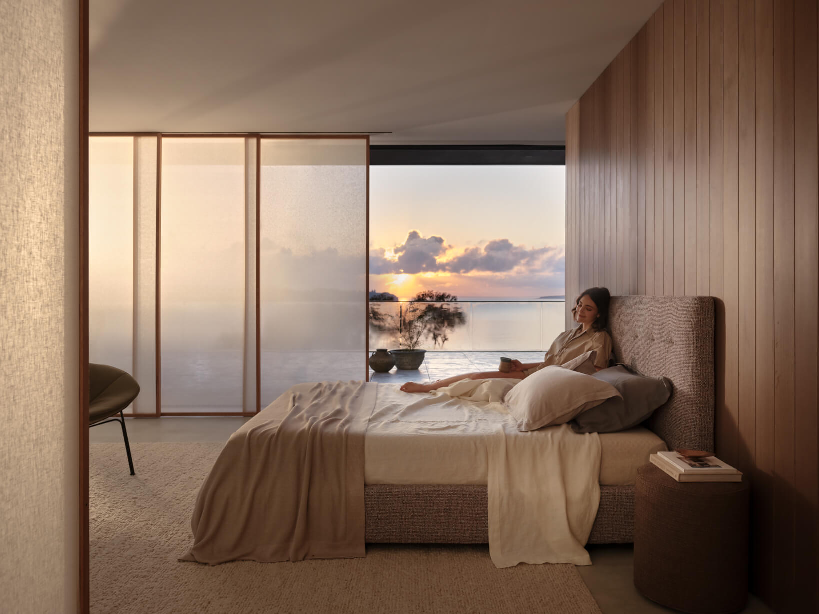 Queen size storage bed with neutral bedding. Timber walls and evening light frame the space, opening to a terrace sunset.
