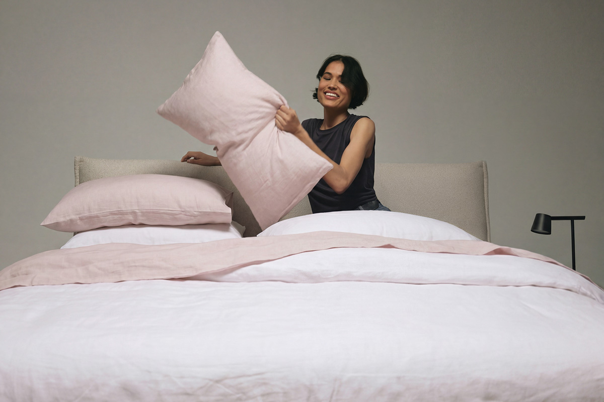 Woman relaxes in a comfortable and modern bed that arrives in a box.