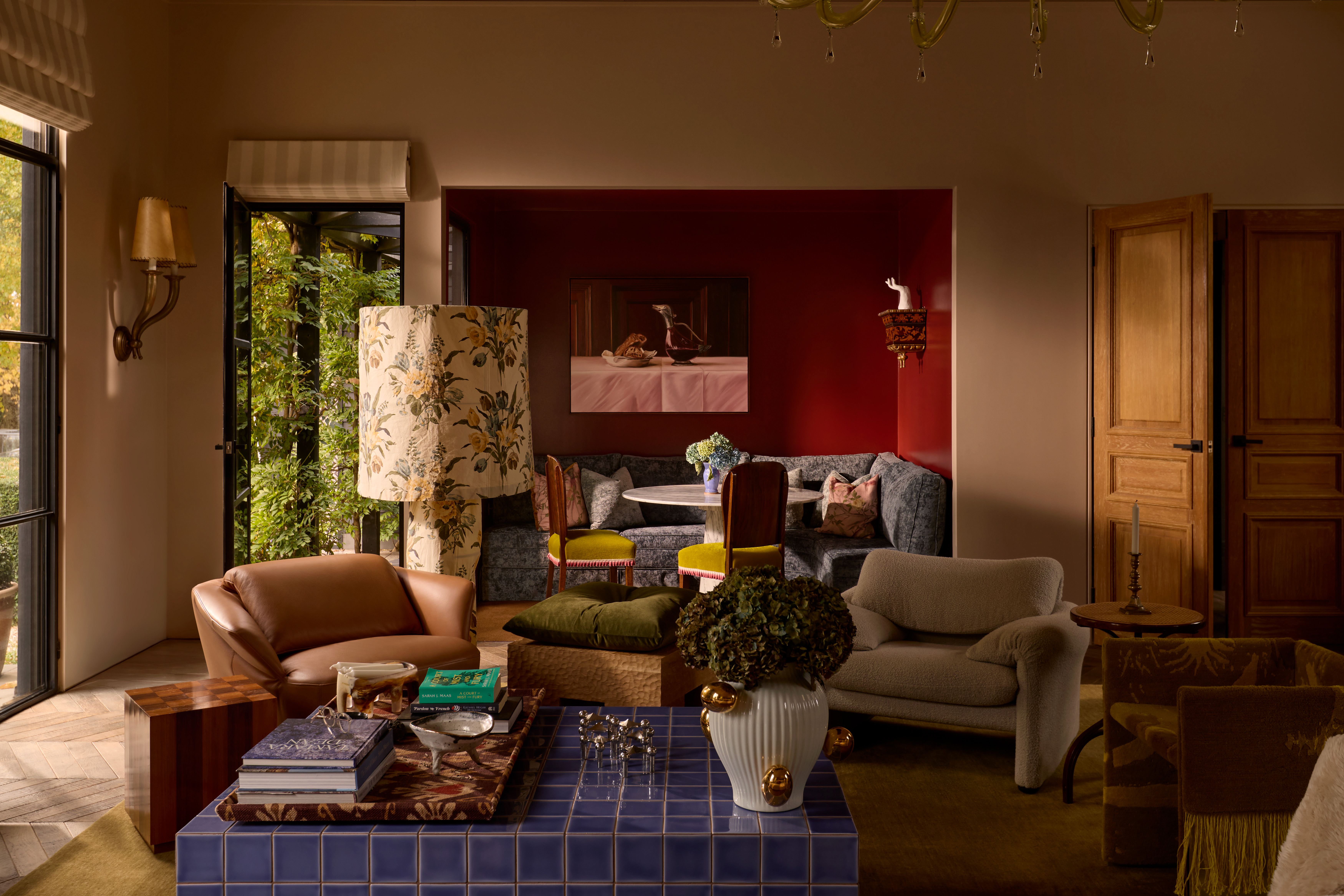 TA bold, layered living room featuring moody colours, sculptural seating, textural depth that is expressively styled.