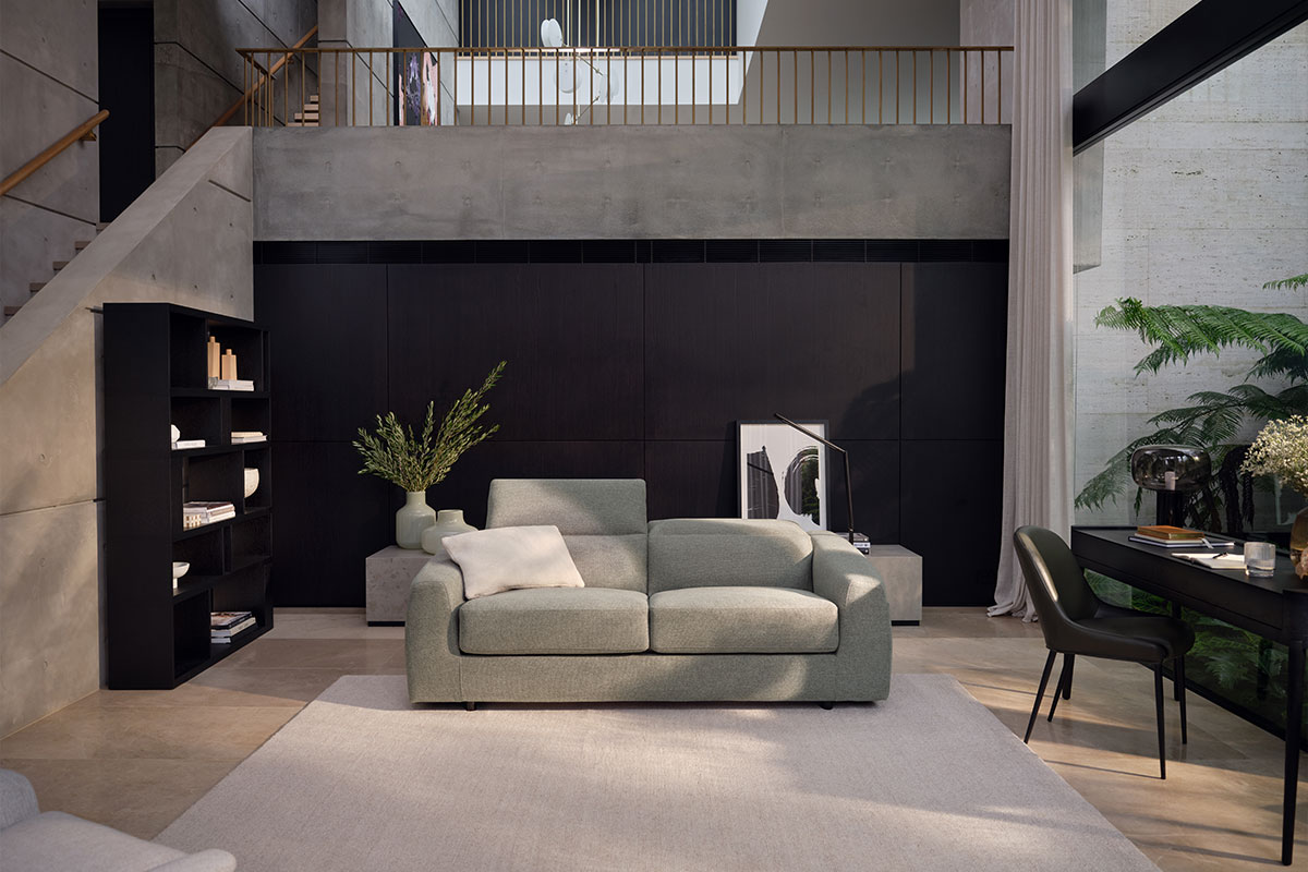 A contemporary living room with a light green sofa bed and dark wooden bookcase and desk.