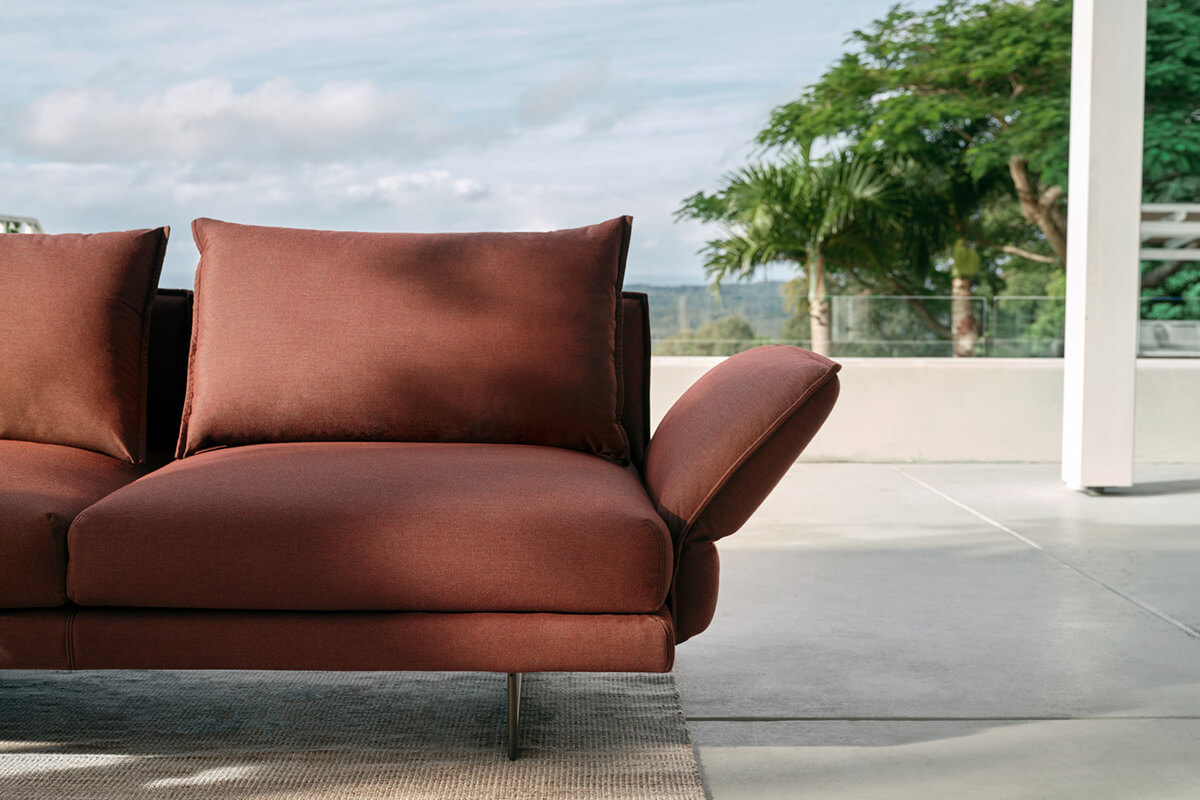 A warm autumnal outdoor fabric styled on outdoor contemporary modular sofa.