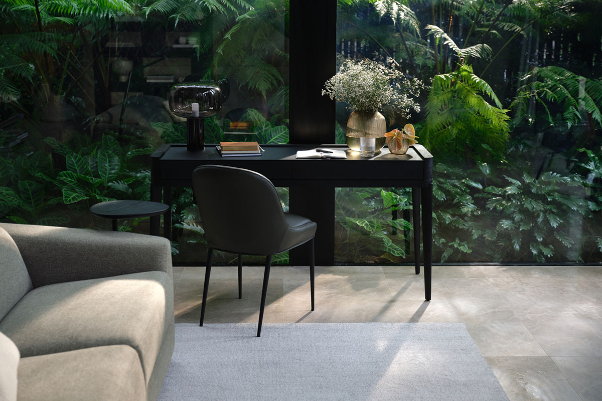 Study and workspaces styled with views of greenery, dark timber surfaces, and natural textures in muted earthy tones.